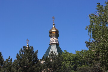 The golden dome of the Orthodox church with a cross