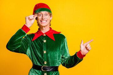 Portrait of his he nice attractive cheerful cheery funny guy elf demonstrating copy empty blank...