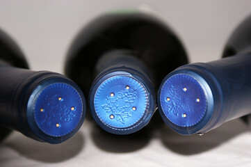 Redwinebottle with a blue cap
