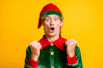 Close-up portrait of his he nice attractive lucky cheerful cheery funny guy elf having fun Eve Noel surprise rejoicing isolated over bright vivid shine vibrant yellow color background