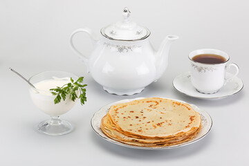 wonderful delicious tea with hot pancakes and fresh sour cream