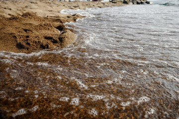 Wave on the sand beach background.