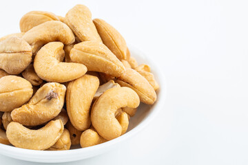 A plate of snacks with salted cashew nuts