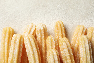 Tasty sweet churros on gray background, top view