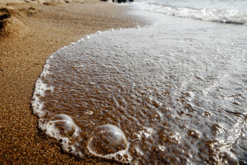 Wave on the sand beach background.