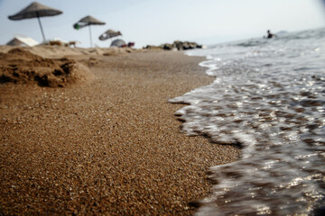 Blurry wave on the sand beach background.