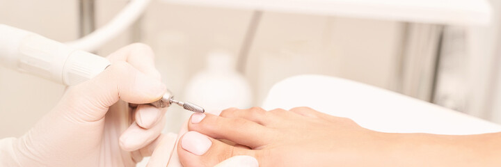 Beautiful salon procedure with pink pedicure on towel background. For decoration design....