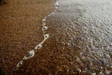 Wave on the sand beach background.