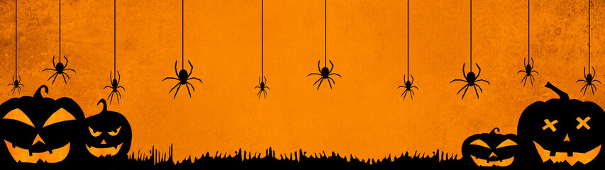 HALLOWEEN background banner wide panoramic panorama template -Silhouette of scary carved luminous cartoon pumpkins and spiders isolated on dark orange night texture