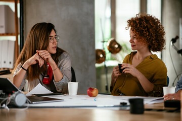 Businesswomen working on a new project. Colleagues discussing work in office