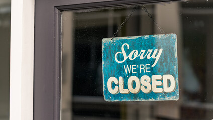 A closed sign hangs on a shop door