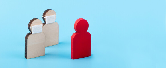 Covid-19 coronavirus , flu and infection concept. Group of wooden little man in a mask surrounded by a little man infected with a virus