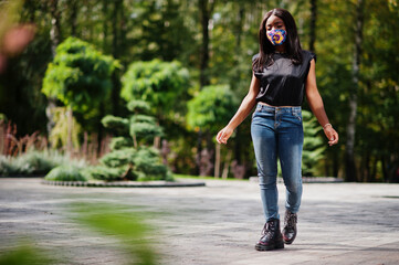 Fashionable african american woman, wear hand made face mask posing outdoor. New normal life.