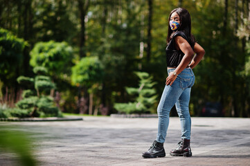 Fashionable african american woman, wear hand made face mask posing outdoor. New normal life.