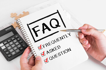 Businessman Writing FAQ Concepts on his Note