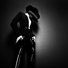 Beautiful fashion woman with perfect body. Portrait of beautiful girl wearing black blazer, latex...