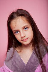 girl with big eyes in a pink bathrobe