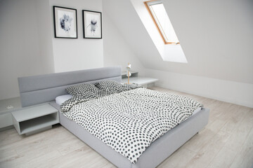 Modern monochrome design home interior of bedroom room in mansard with wooden bed and elegant...