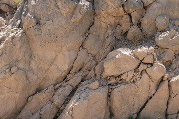 brown rock wall with uneven surface
