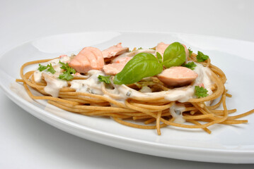 cooked spaghetti with organic salmon and basil