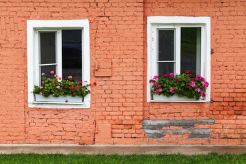 Fototapeta na wymiar Two white windows in old red brick wall