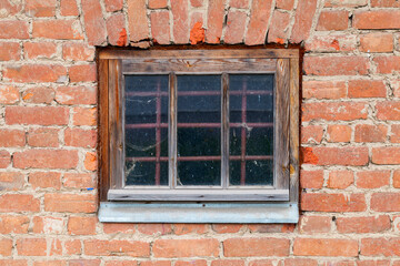 Old locked window with protective metal grate
