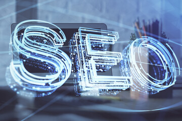 Multi exposure of table with computer and seo drawing hologram. Search optimization concept.