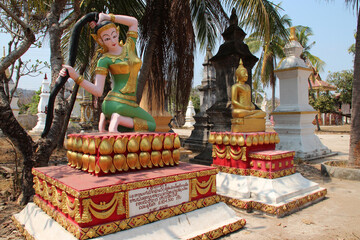 statues of buddhist divinities in a temple on khong island in laos