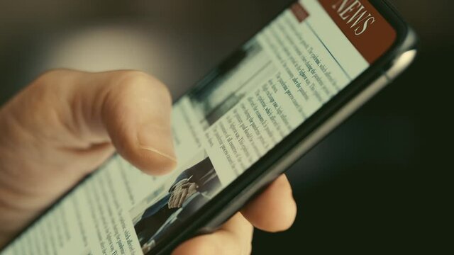 Reading news on mobile phone	
