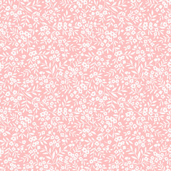 Vintage floral background. Seamless vector pattern for design and fashion prints. Flowers pattern with small white flowers on a light pink background. Ditsy style.