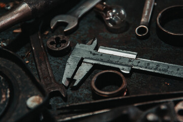 Obraz na płótnie Canvas caliper garage old tool on the workbench stand wheel wrenches screwdriver