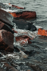 waves hitting stones on the shore in the black sea during a storm - 384132131