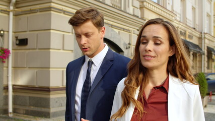 Closeup couple talking together outside. Business man and woman discussing work
