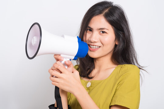 Portrait Asian Beautiful Young Woman Standing Smile Holding And Shouting Into Megaphone Looking To Space, Shoot The Photo In A Studio On A White Background, There Was Copy Space