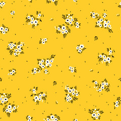 Cute floral pattern in the small flowers. Seamless vector texture. Elegant template for fashion prints. Printing with small white flowers. Bright yellow background.