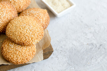 cookies with sesame seeds on gray concrete background. Healthy snack with sesame
