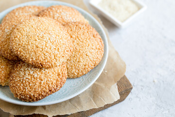 cookies with sesame seeds on gray concrete background. Healthy snack with sesame