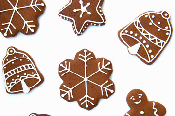 Tasty homemade Christmas gingerbread cookie of various shapes with sugar glaze on white background