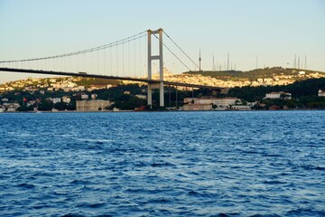 Tourist boats sail under the bridge in Istanbul. Traveling on the Bosphorus. Panoramic view, View of the First Bosphorus Bridge sailling Bosporus.