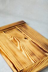 Wood cutting board on grey background