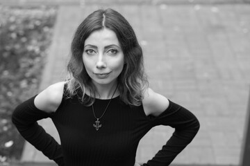 Portrait of beautiful woman outside in black and white