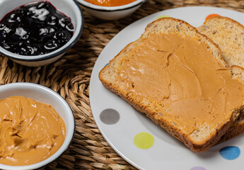 Breakfast. Peanut butter and jelly sandwich on wooden background.