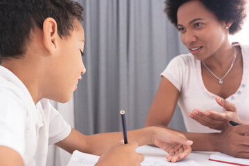 Mother helping son with homework