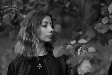 Portrait of beautiful woman outside in black and white