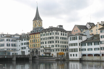 Fototapeta na wymiar Beautiful view of the St Peter's Church , historic city center , and Limmat river in Zurich, Switzerland.