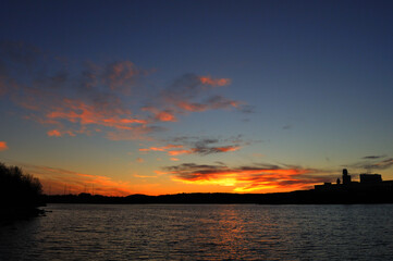 Naklejka premium Bright sun sunset over water, Beautiful background wallpaper.