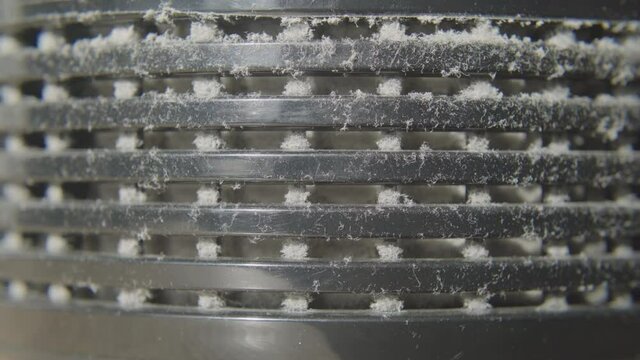 Close up on a dusty air purifier vent. 4K.