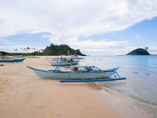 Fototapeta na wymiar Traditional blue long tail boat on a beach in Palawan, Philippines