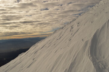 Mountain climbing during the sunrise on the snow covered active Volcan Villarrica in Pucon, Chile
