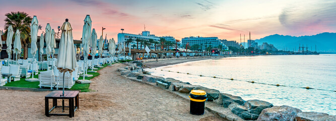 Panoramic nocturnal view on the central public beach of Eilat - famous tourist  resort and...